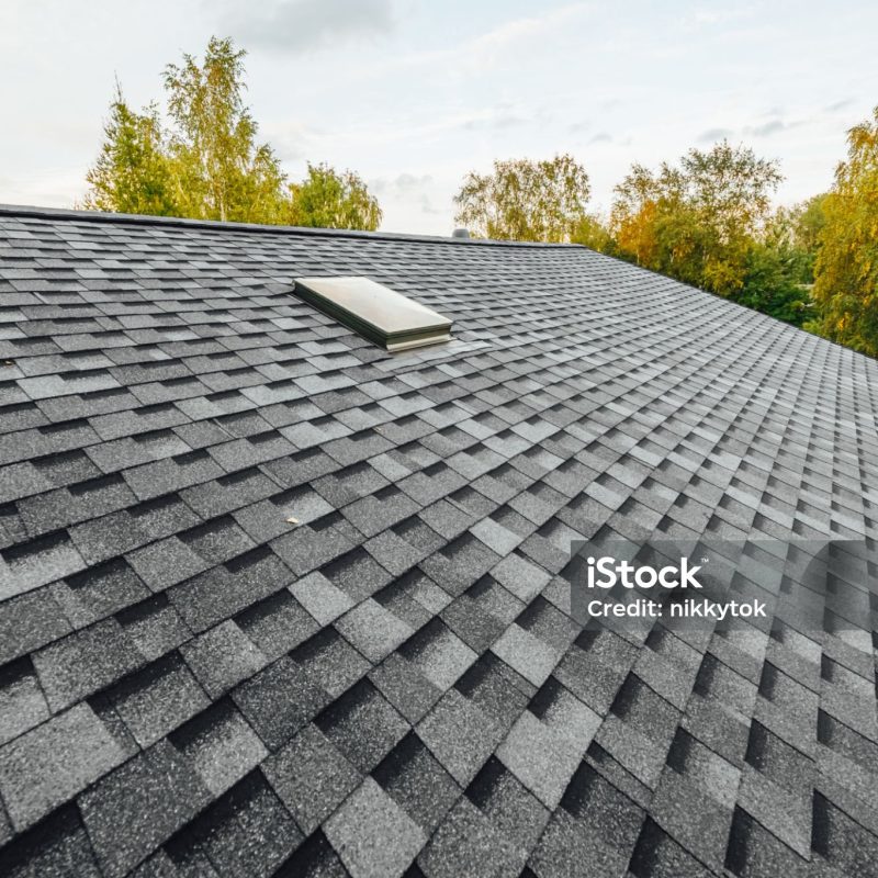 roof of new house with shingles roof-tiles and ventilation window